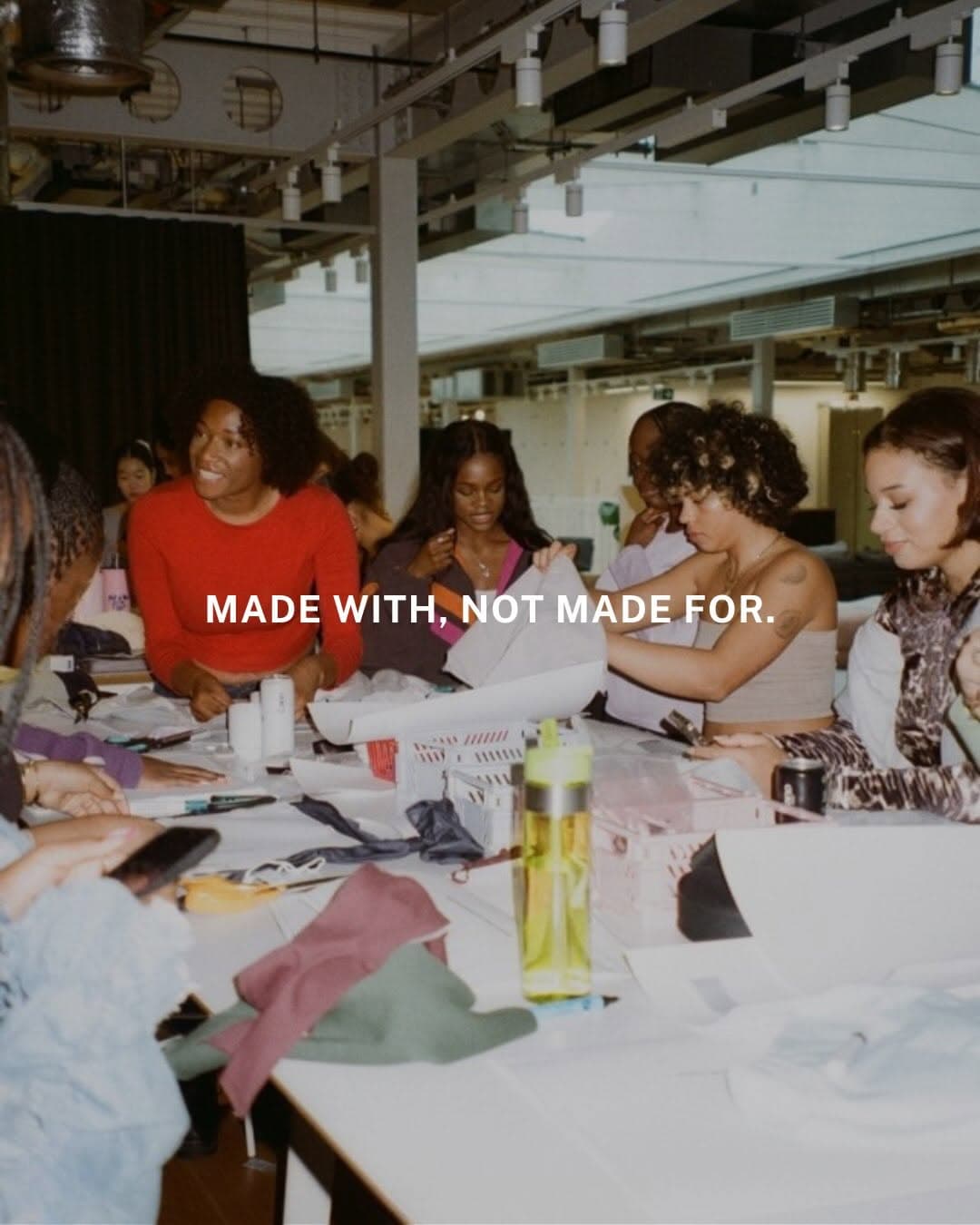 Community members gathered at a Nike Re-Created collection workshop with Babes on Waves Club, collaborating on creative designs alongside designer Tega Akinola in an interactive brand activation event