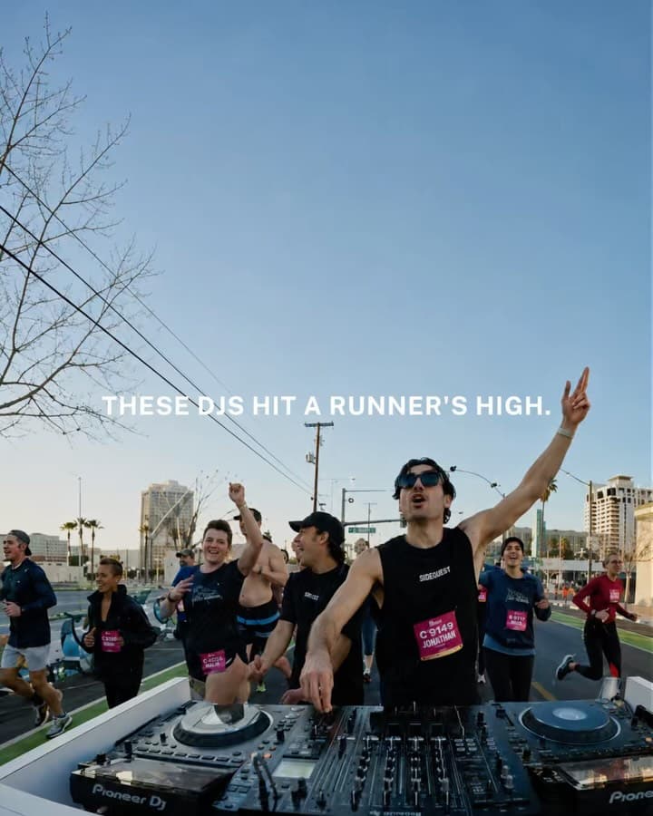 DJ performing with equipment while running in a race, wearing athletic gear and headphones, participating in Rock 'n' Roll Vegas 5K alongside other runners